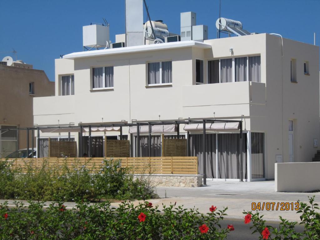 ein weißes Gebäude mit vielen Fenstern in der Unterkunft Sunny Holiday Apartments in Protaras