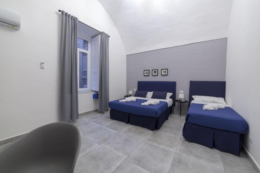 a room with two beds and a mirror at Bell'eBBuono Suite in Naples