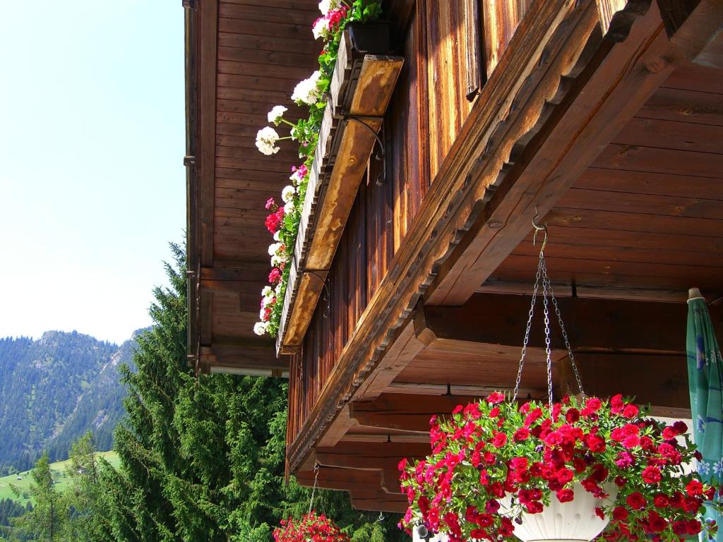 a hanging basket of flowers on the side of a building at Kaiserhof in Alpbach