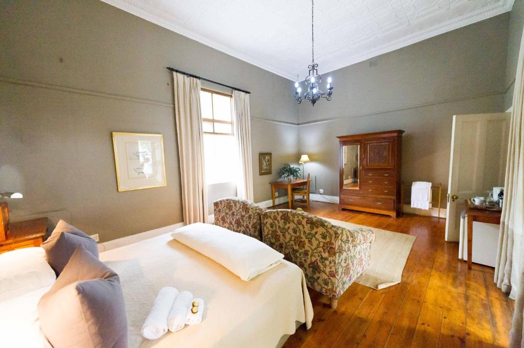 a hotel room with a bed and a couch at Osborne House in Pretoria