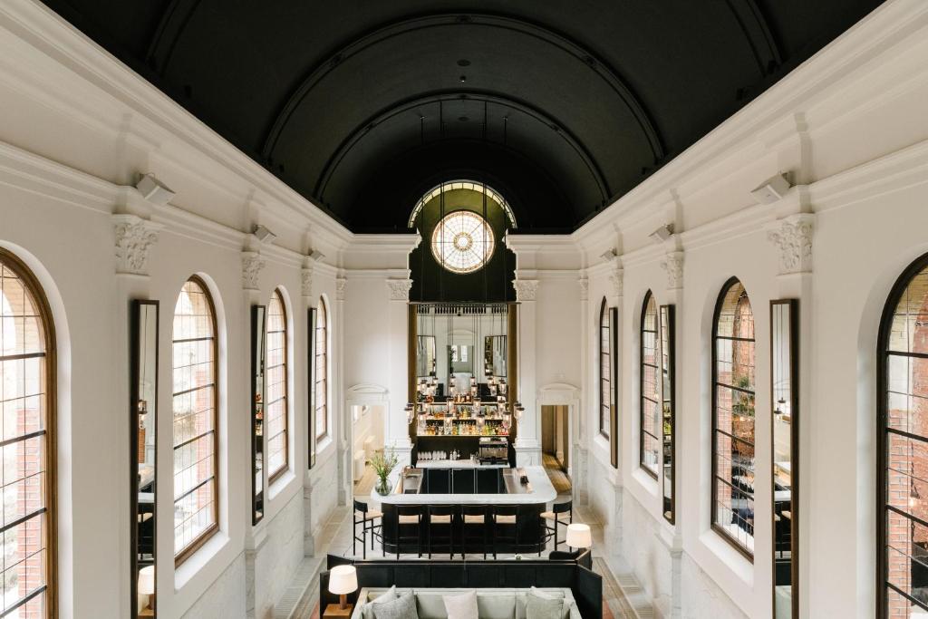 a large room with a clock on the ceiling at august in Antwerp