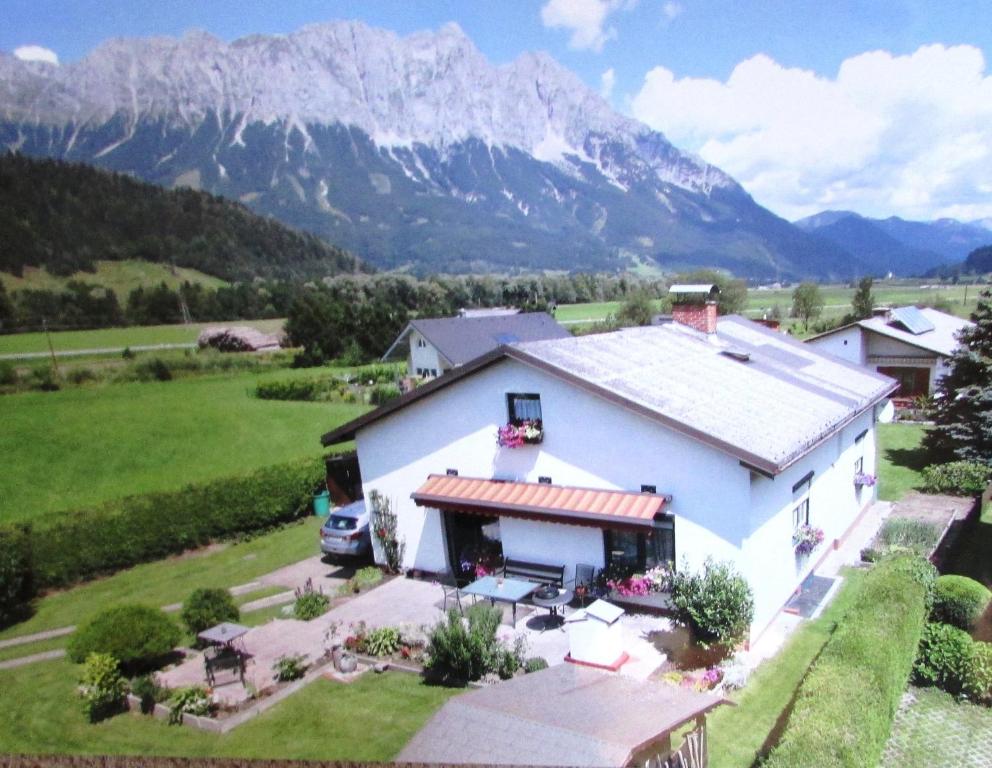 an aerial view of a white house with mountains in the background at Haus Danklmaier in Öblarn