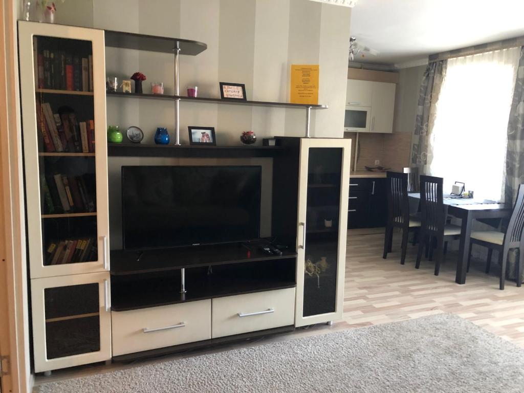 a large entertainment center with a television in a living room at Bon Voyazh in Velikiye Luki