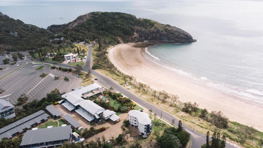 an aerial view of a beach and the ocean at Rosslyn Bay Resort Yeppoon in Yeppoon