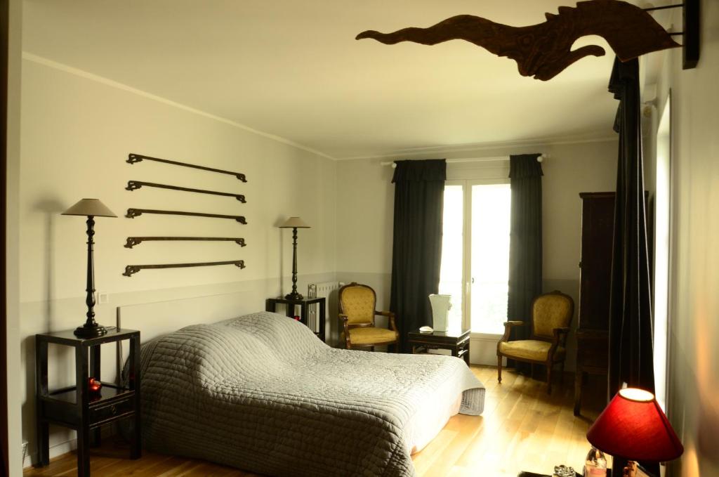 Кровать или кровати в номере La Maison du Palmier