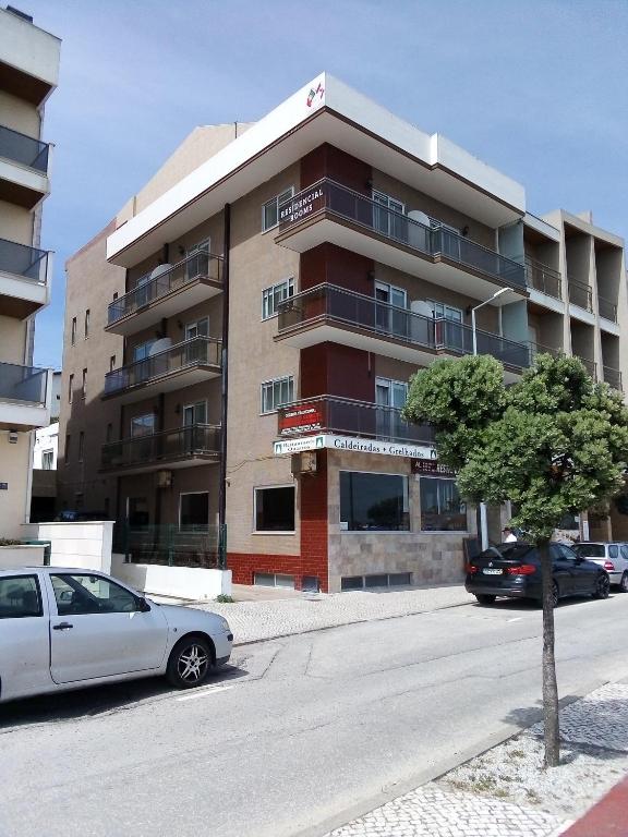 a white car parked in front of a building at Canadian Star in Praia de Mira