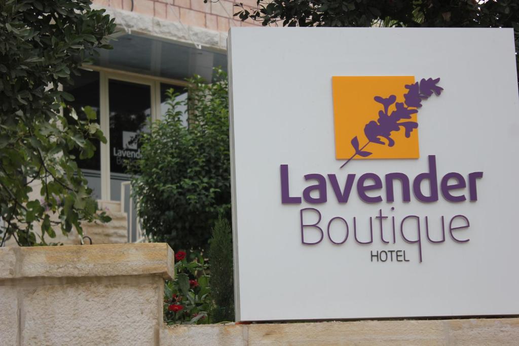 a sign in front of a leander boutique hotel at Lavender Boutique Hotel in Ramallah