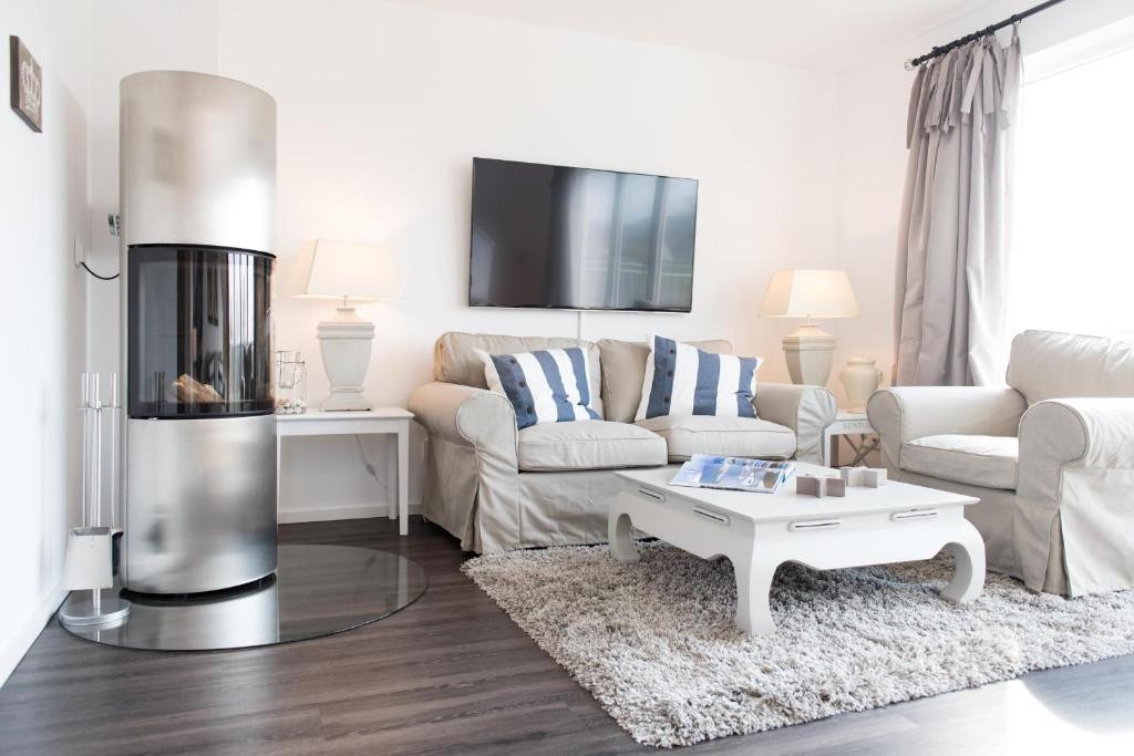 a living room with a couch and a coffee table at Möwenblick in Olpenitz