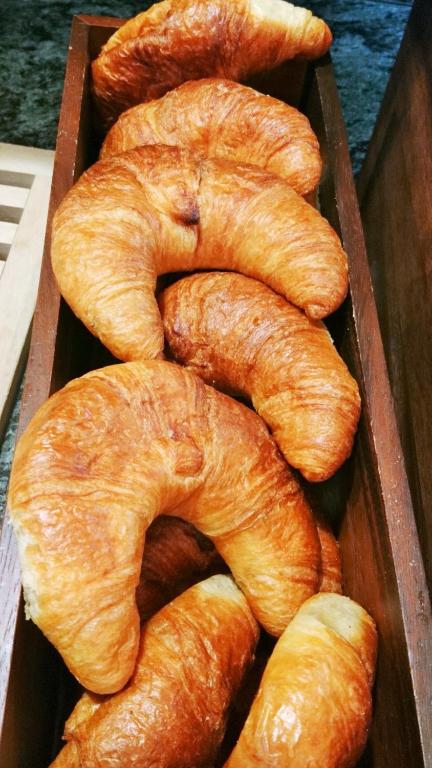 a group of croissants in a wooden box at Altötting City Apartments in Altötting