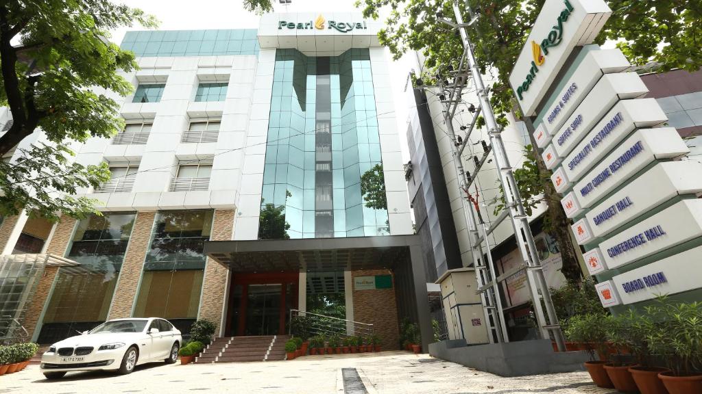 a car parked in front of a building at PEARL ROYAL INTERNATIONAL HOTELS & RESORTS PVT LTD in Thodupuzha