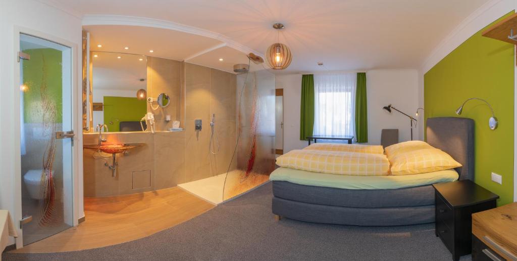 a bedroom with a bed and a bathroom with a shower at Altötting City Apartments in Altötting