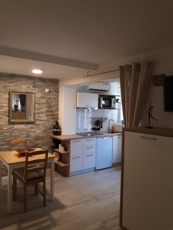 a kitchen with a table and a dining room at Apartments No 55 in Baška