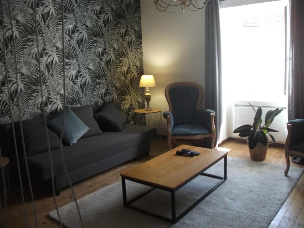 a living room with a couch and a coffee table at L'Inattendue in Chaumont