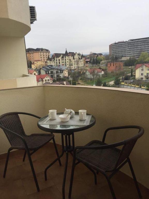 a table and chairs on a balcony with a view at Studio with separate bed room in Truskavets