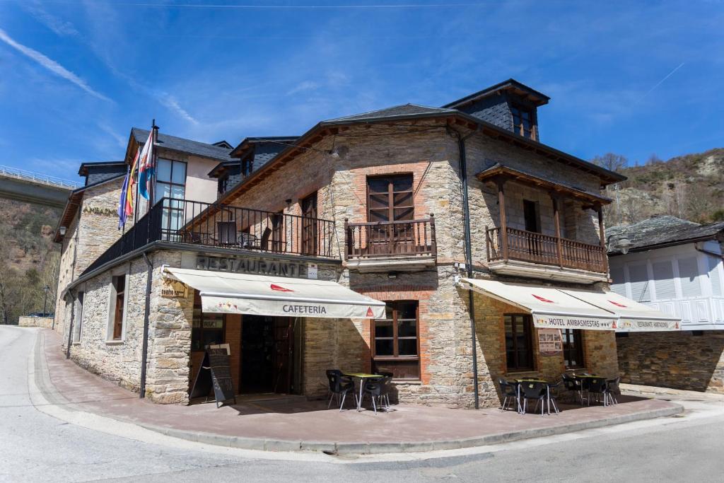 a building with tables and chairs in front of it at Hotel Ambasmestas in Ambasmestas