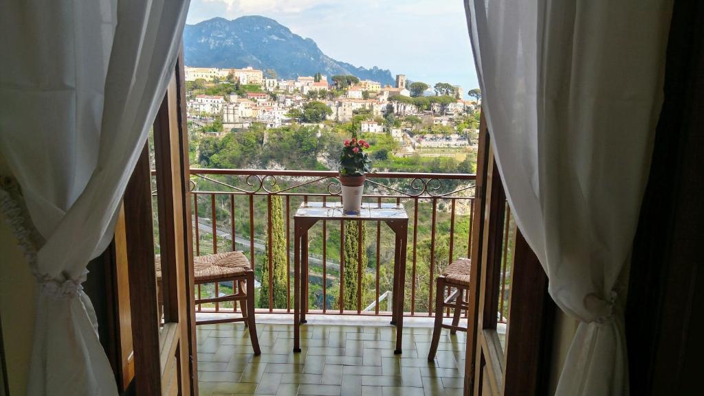a balcony with a table and a view of a city at Ravello View in Scala