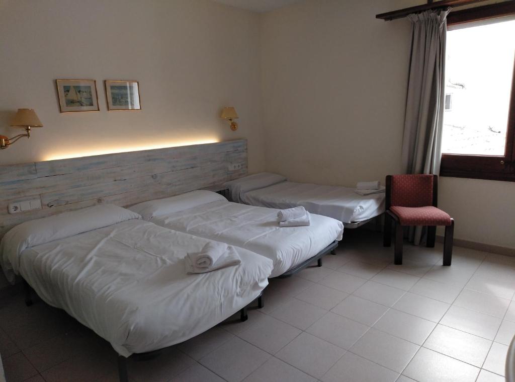 Postel nebo postele na pokoji v ubytování Hotel Corisco