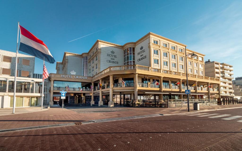 a large building with a clock on the side of it at Hotel Van Oranje in Noordwijk aan Zee