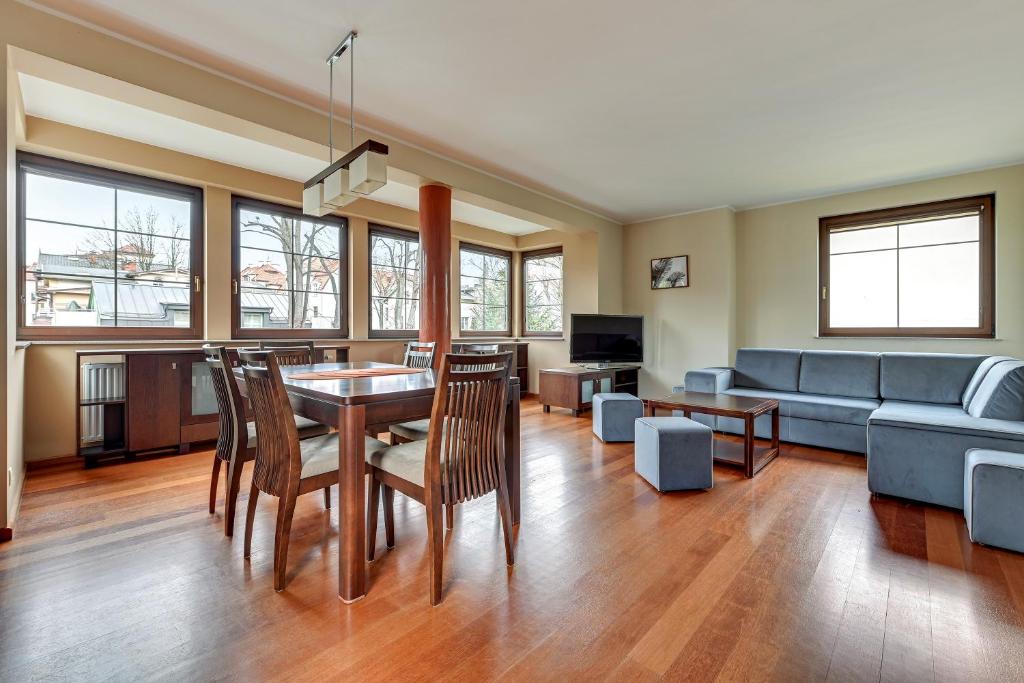 a living room with a table and a couch at Blue Mandarin Apartments in Sopot