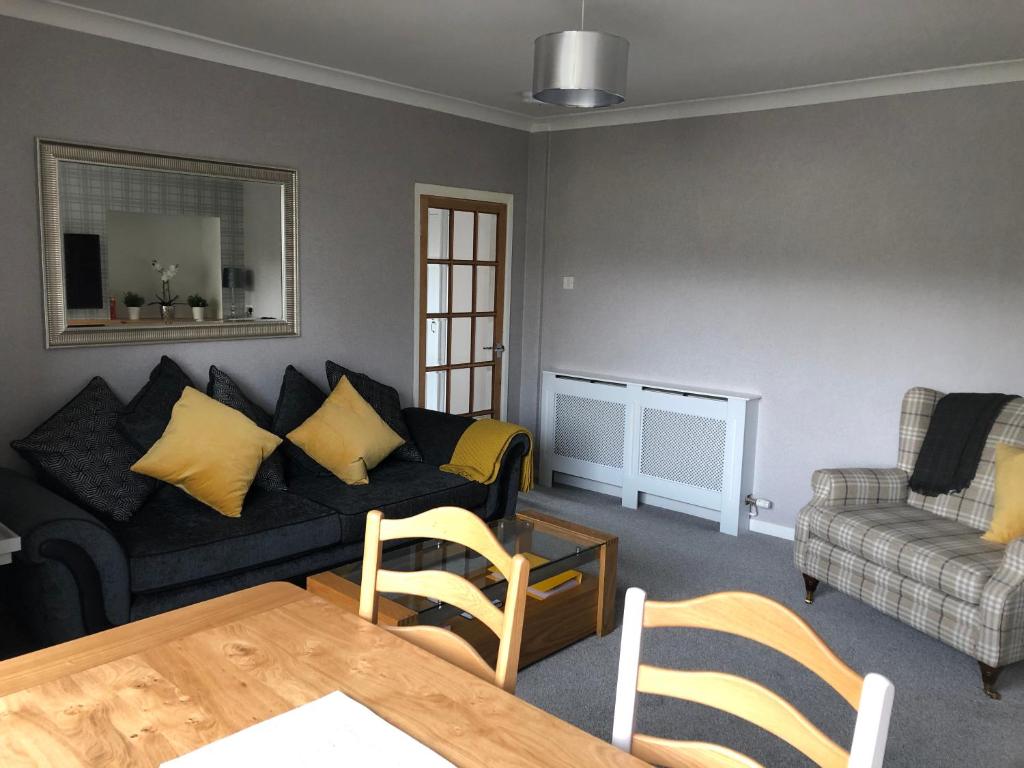 a living room with a couch and a table and chairs at Old Police House Causewayhead Stirling in Stirling