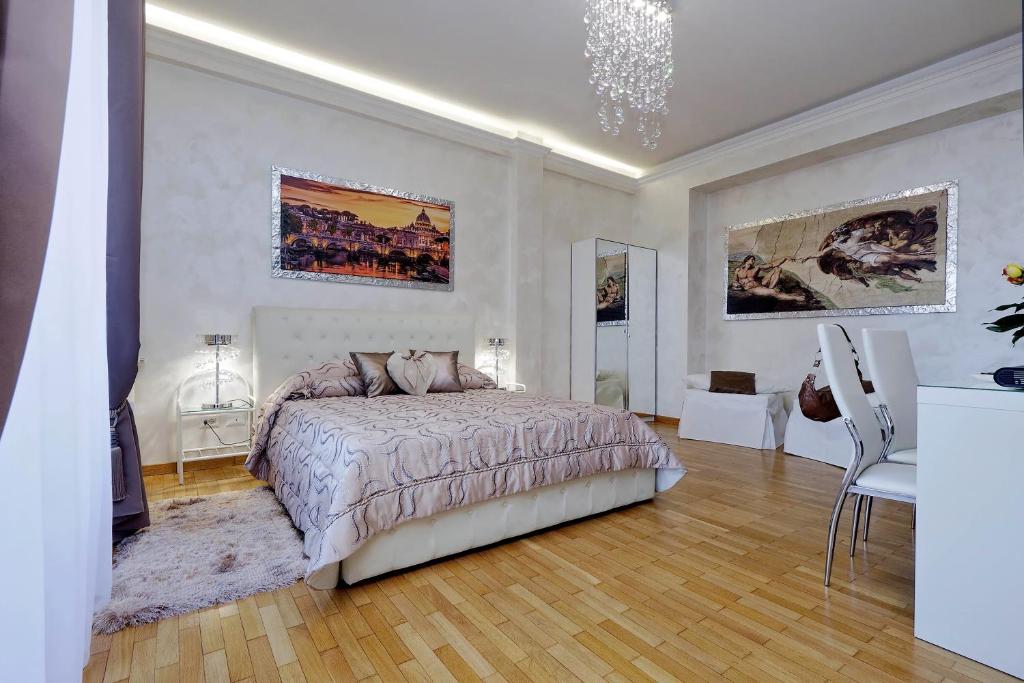 a bedroom with a bed and a table and chairs at Luxury Rome Guest House in Rome