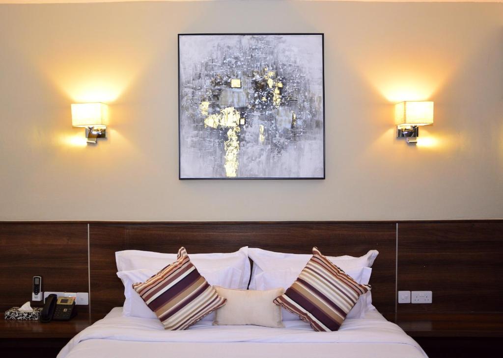 Postel nebo postele na pokoji v ubytování Razana Hotel