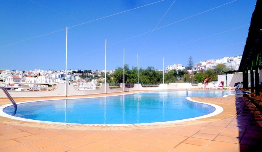 a large swimming pool with a view of a city at Varandas do Mar by Sunny Deluxe in Albufeira