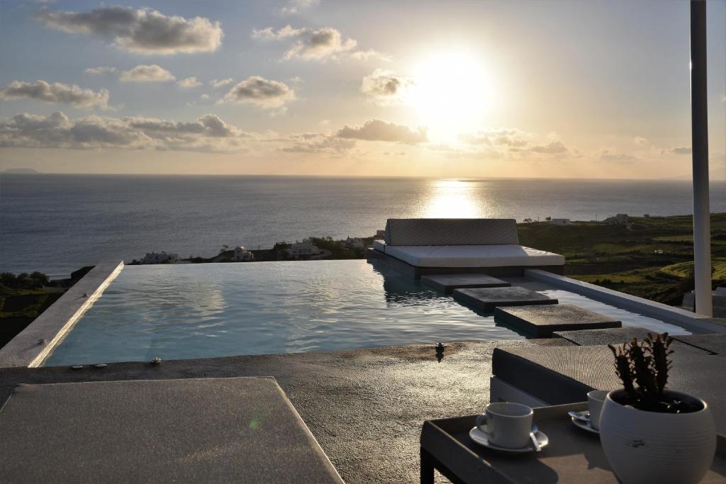 a pool with a view of the ocean from a house at Horizon Mills in Imerovigli