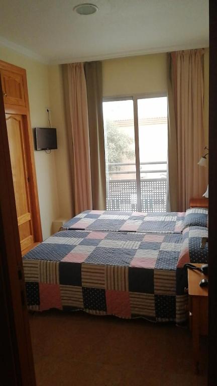 Postel nebo postele na pokoji v ubytování Hotel Paloma