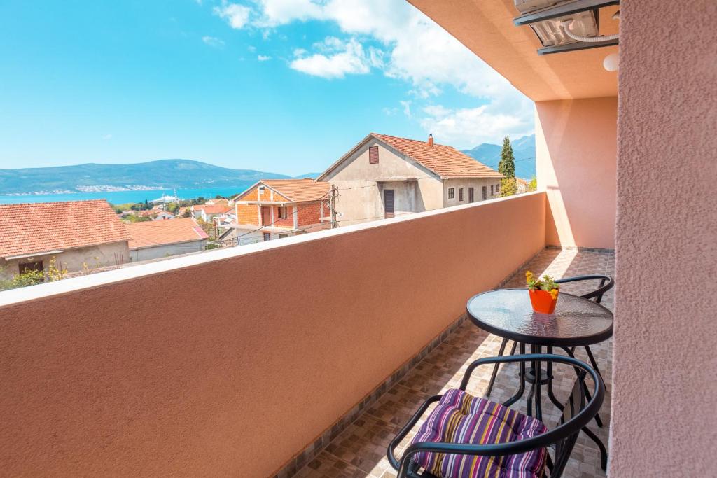 a balcony with two chairs and a table with a view at Libra Apartments in Tivat