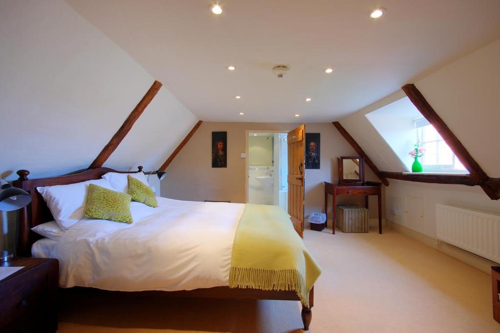 a bedroom with a large bed in a attic at Sutherland House in Southwold