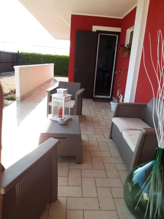 a patio with couches and a table and a vase at Valeri 's Country House in Sperlonga