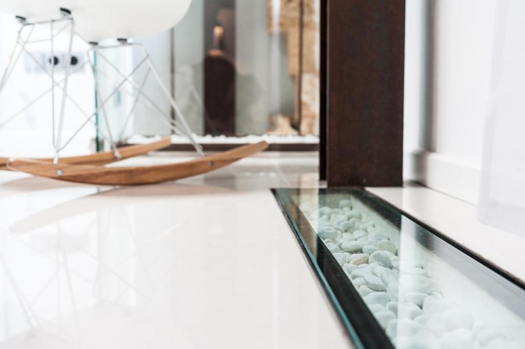 a glass table with a model boat on top of it at Can Vent Boutique Hotel in Alcudia