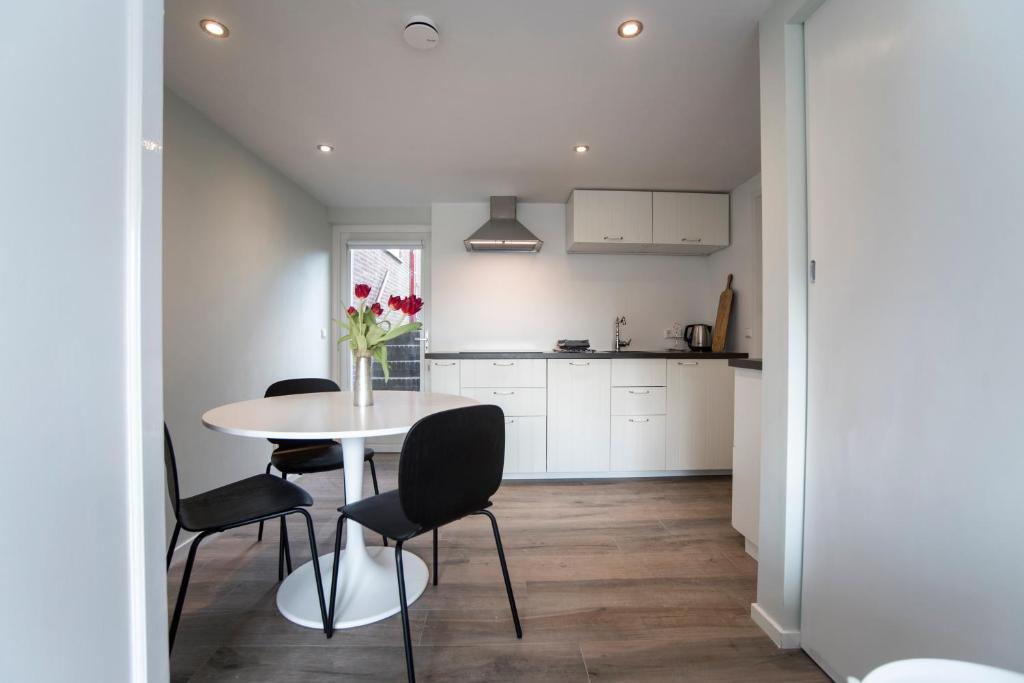 een keuken en eetkamer met een tafel en stoelen bij New Point in Zandvoort