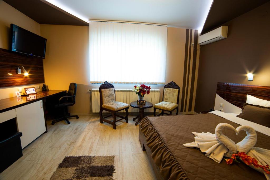 Postel nebo postele na pokoji v ubytování Garni Hotel Lama