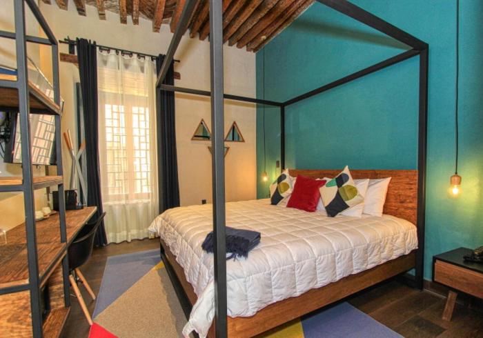 Postel nebo postele na pokoji v ubytování Antigua Trece Hotel Fusión