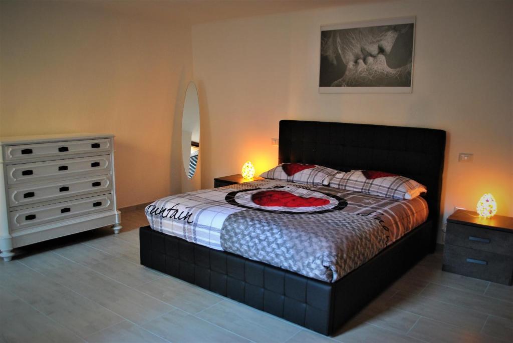 una camera con un letto e un comò con due lampade di H2O RELAX APARTMENT a San Pellegrino Terme