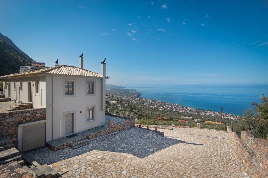 
a house with a view of the ocean at Bay View GuestHouses in Kalamata
