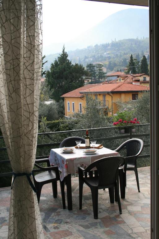 a table and chairs sitting on a patio at La terrazza sugli ulivi in Toscolano Maderno