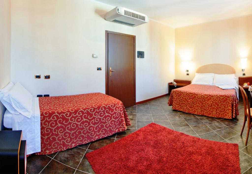Posteľ alebo postele v izbe v ubytovaní Antico Albergo Madonna
