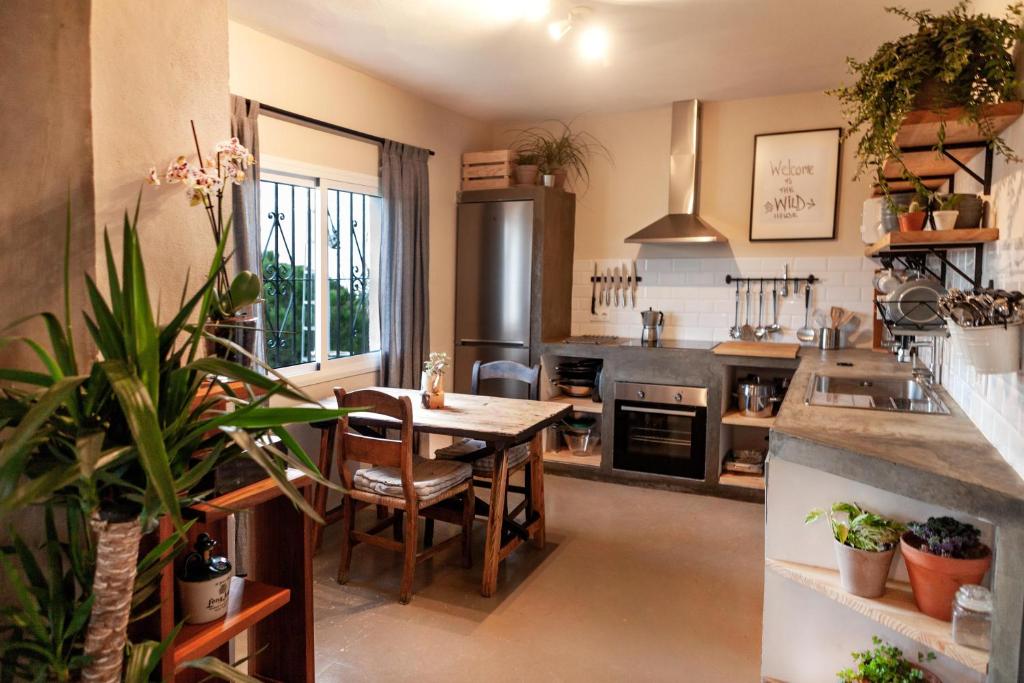 a kitchen with a table and a dining room at Wild House Tarifa in Tarifa