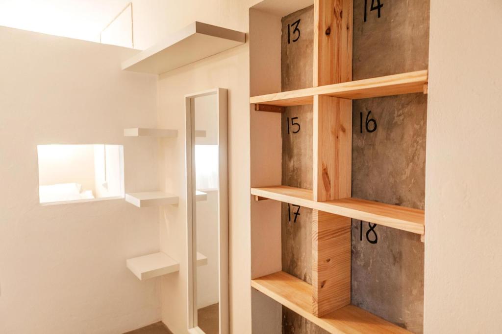 a walk in closet with wooden shelves and a mirror at Wild House Tarifa in Tarifa