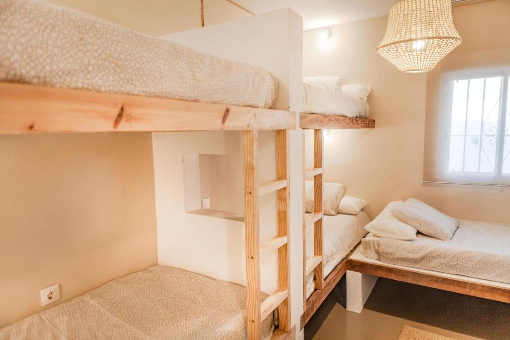 a room with two bunk beds and a window at Wild House Tarifa in Tarifa