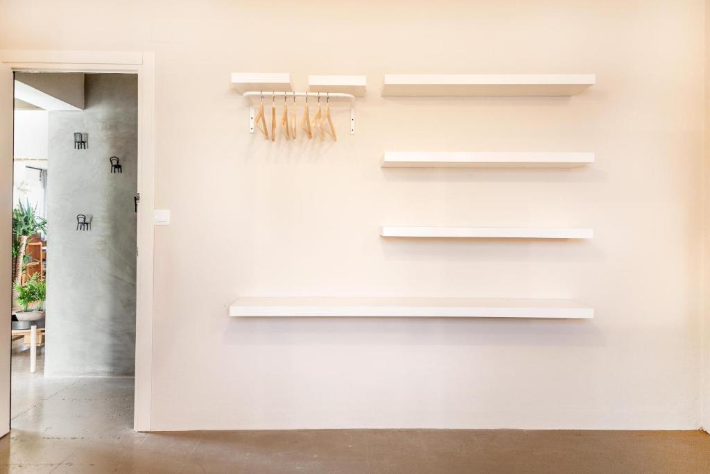 a room with white walls and white shelves at Wild House Tarifa in Tarifa