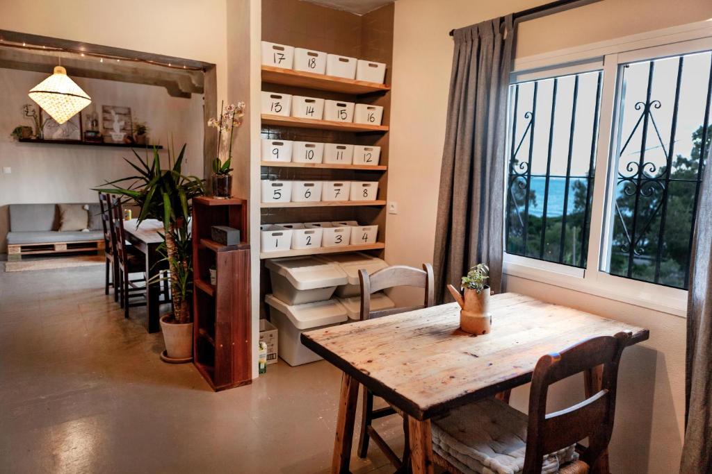 a dining room with a table and a window at Wild House Tarifa in Tarifa