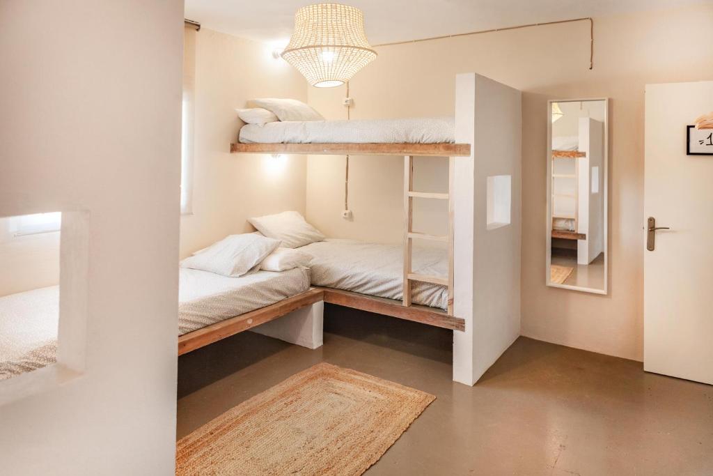 a room with two bunk beds and a mirror at Wild House Tarifa in Tarifa