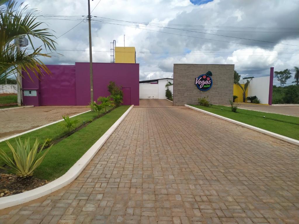 a brick road in front of a purple building at VEGAS MOTEL in Imperatriz