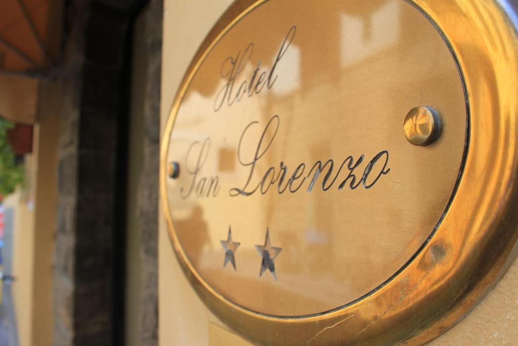 a clock on the side of a store window at Hotel San Lorenzo in Florence
