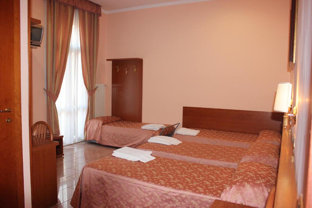 Postel nebo postele na pokoji v ubytování Hotel Aristotele