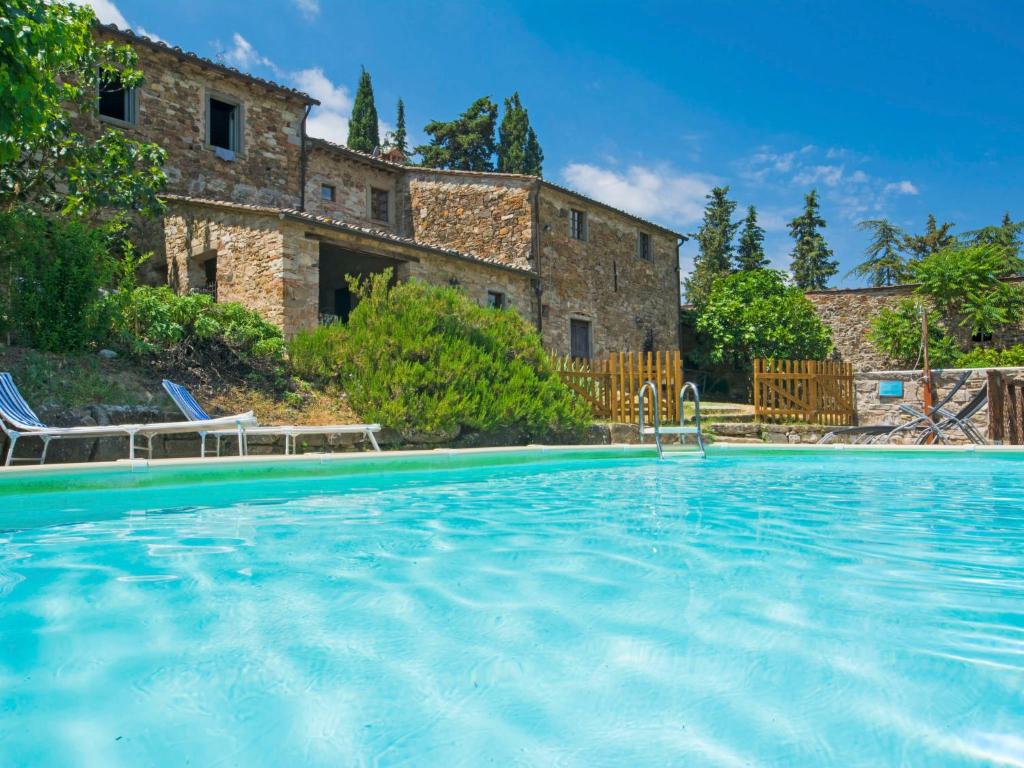 a large swimming pool in front of a building at Holiday Home Le Bonatte-1 by Interhome in Radda in Chianti